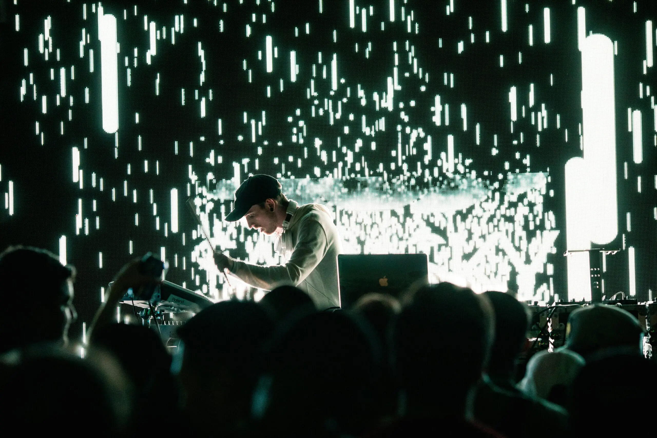 Live visual artist performing beat-synced visuals at a high-energy event